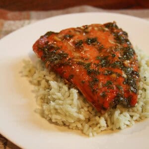 Glazed salmon fillet with honey cilantro ginger sauce served over herbed green rice.