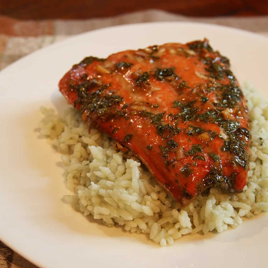 Glazed salmon fillet with honey cilantro ginger sauce served over herbed green rice.